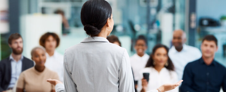Rearview shot of an unrecognizable businesswoman giving a presentation in the office boardroom