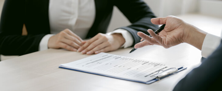 Business people negotiating and signing a contract.